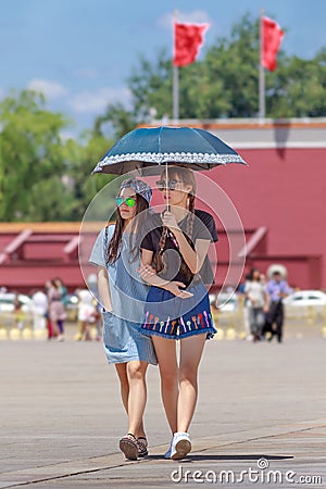 Young fashionable girls on a sunny Tiananmen Square, Beijing, China Editorial Stock Photo